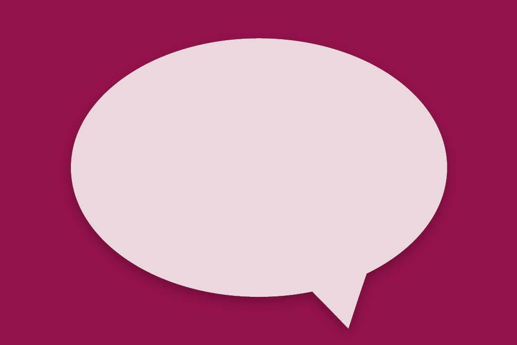 People walking through a bright indoor hallway with glass walls and shops.