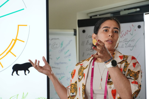 A student at the Bootcamp presenting her team's solution.