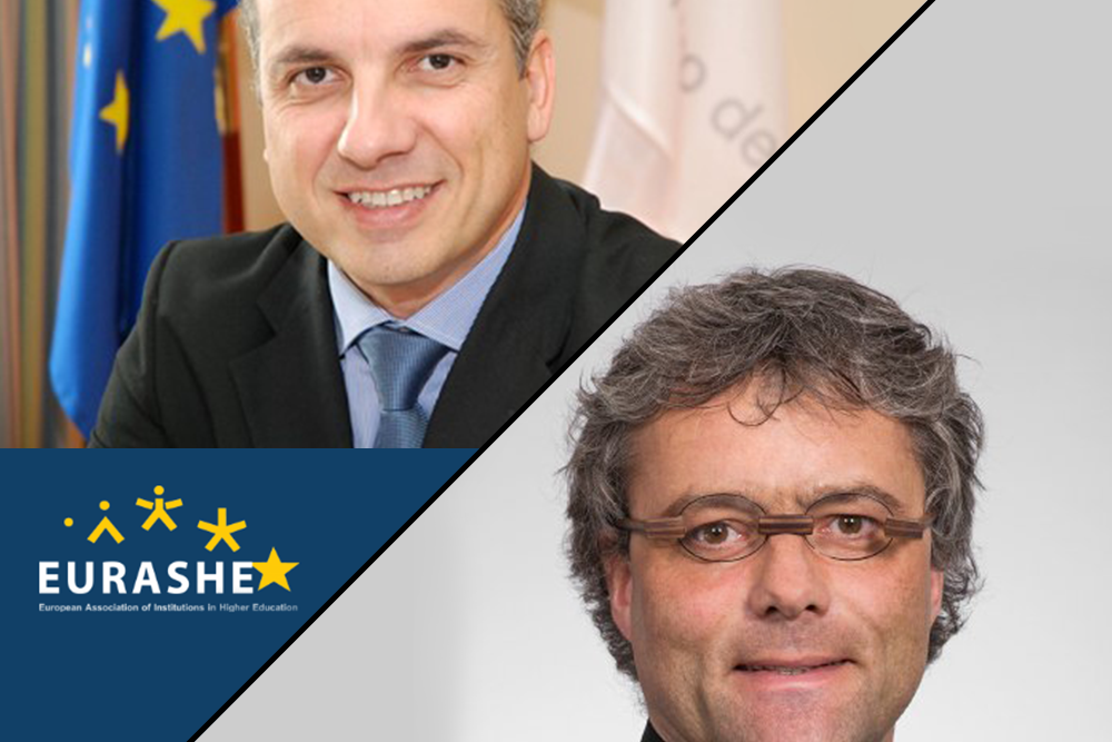 People walking through a bright indoor hallway with glass walls and shops.