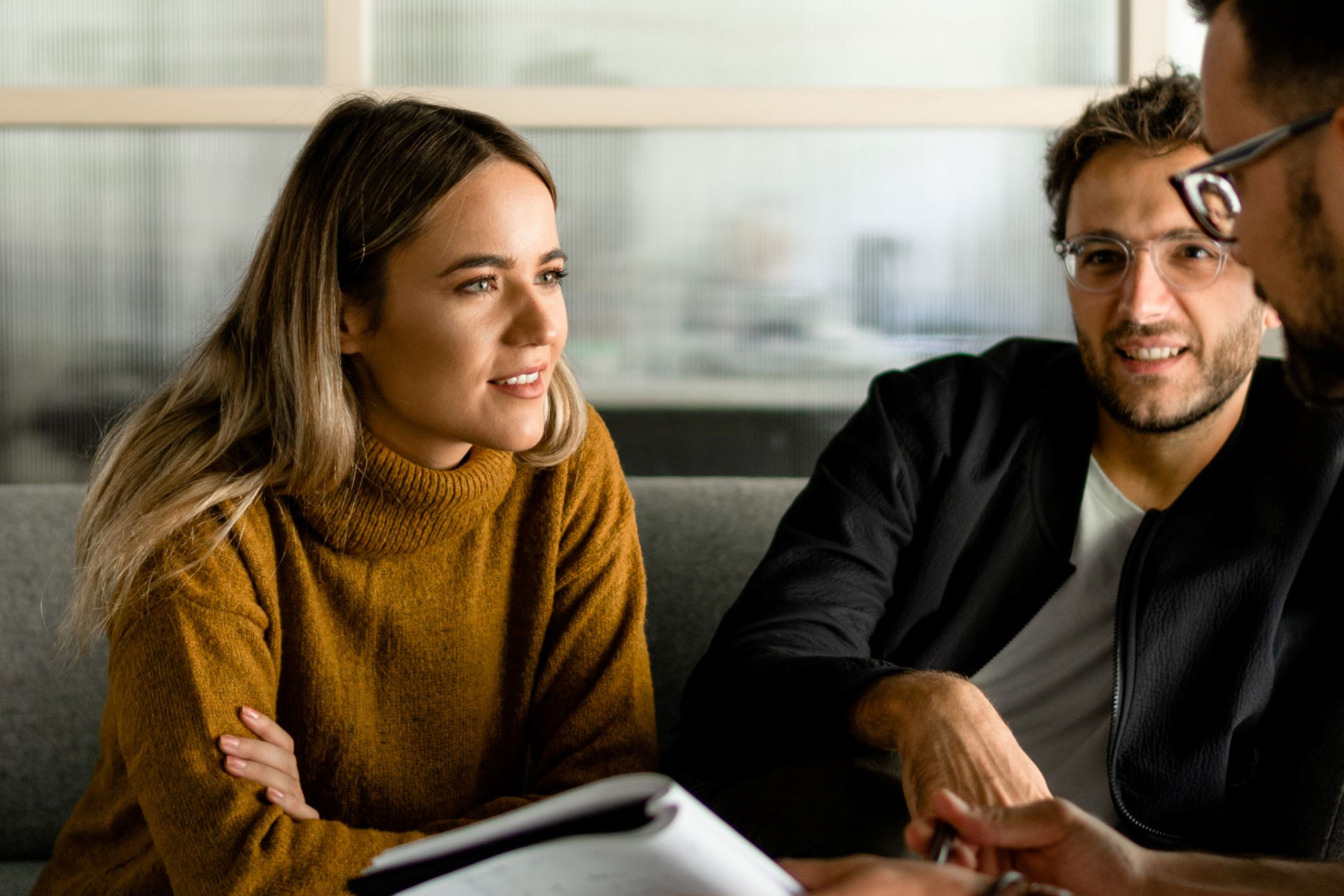 A photo of a group of people in a entrnovators meeting, woman pointing at a chart.